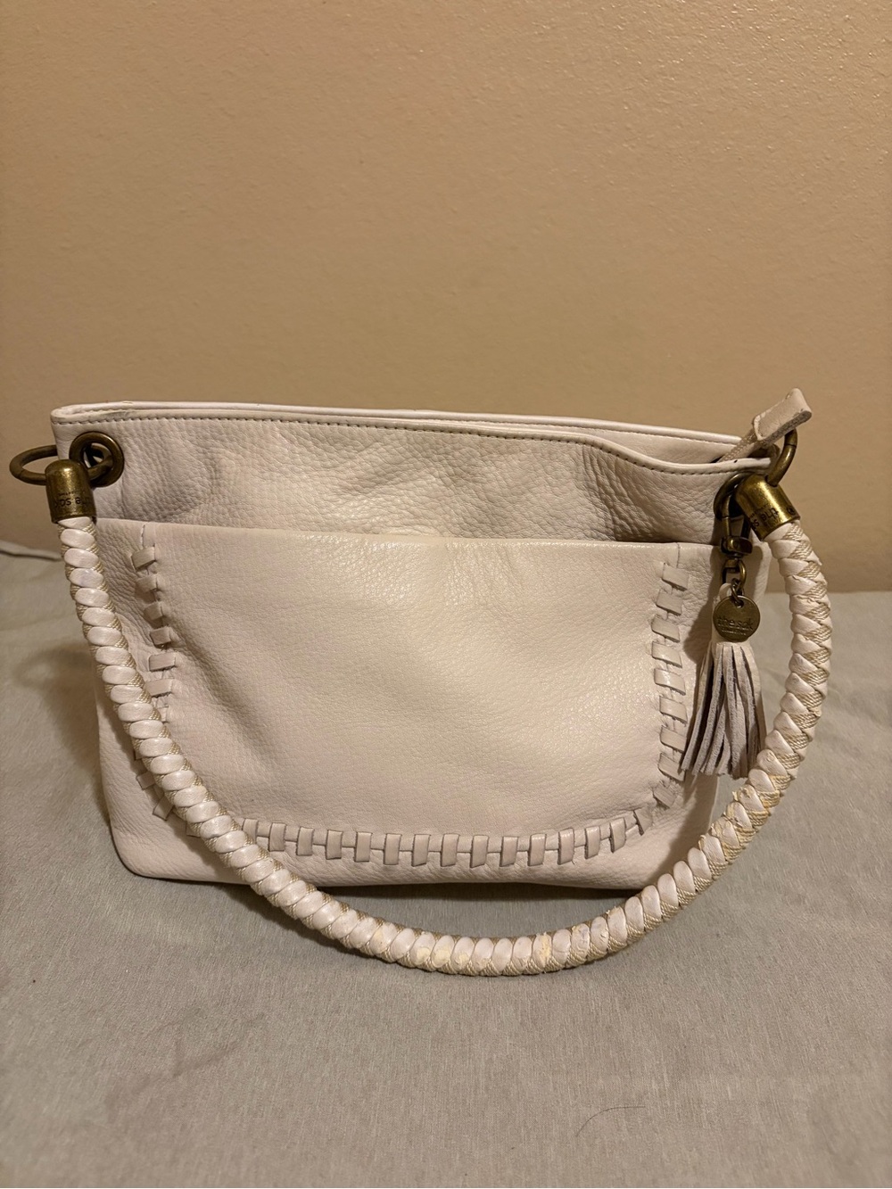 The Sak White Leather Shoulder Bag with Braided Handle and Tassel Charm